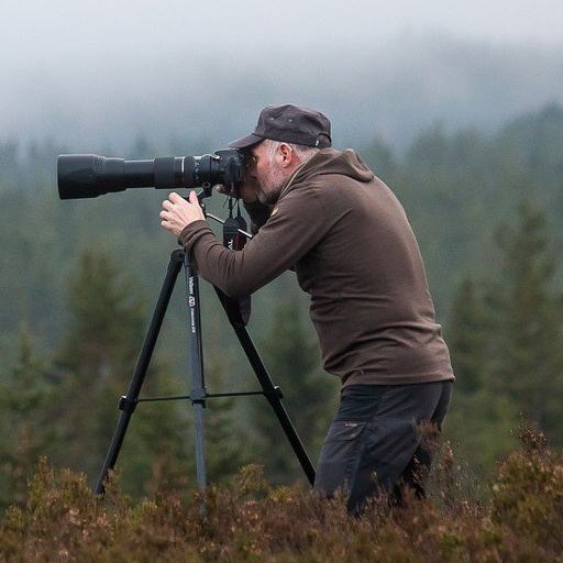 photo of a naturalist with a long lensbinoculars